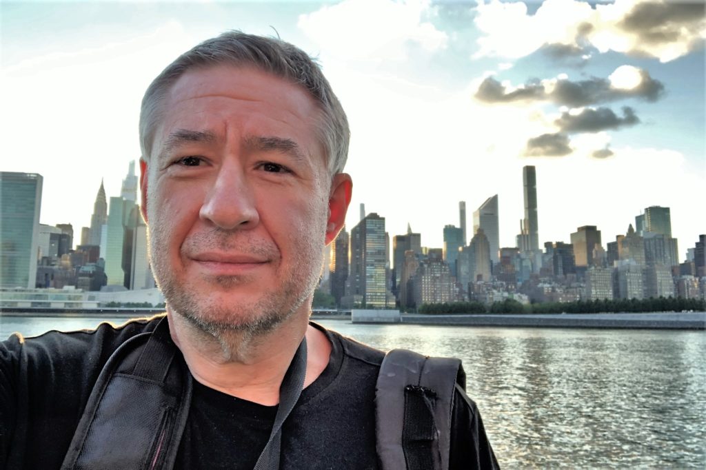 Author Steve Wright — at home in urban walkable places — NYC skyline from East River — Gantry Plaza State Park Queens
