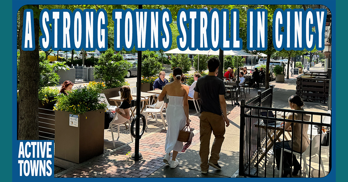 A couple holding hands and strolling a sidewalk cafe in Cincinnati