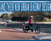 Families riding bikes in a protected bike lane and protected intersection