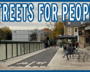 Transformed street with a two way cycle track and expanded pedestrian area and cafe seating