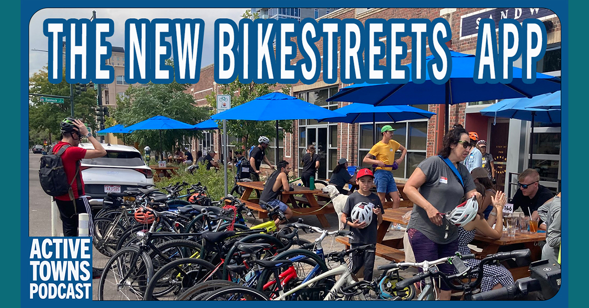 A large group of parked bicycles and outdoor cafe seating with several people