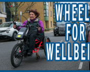 Isabelle is riding on an adaptive cycle on a quiet street in London