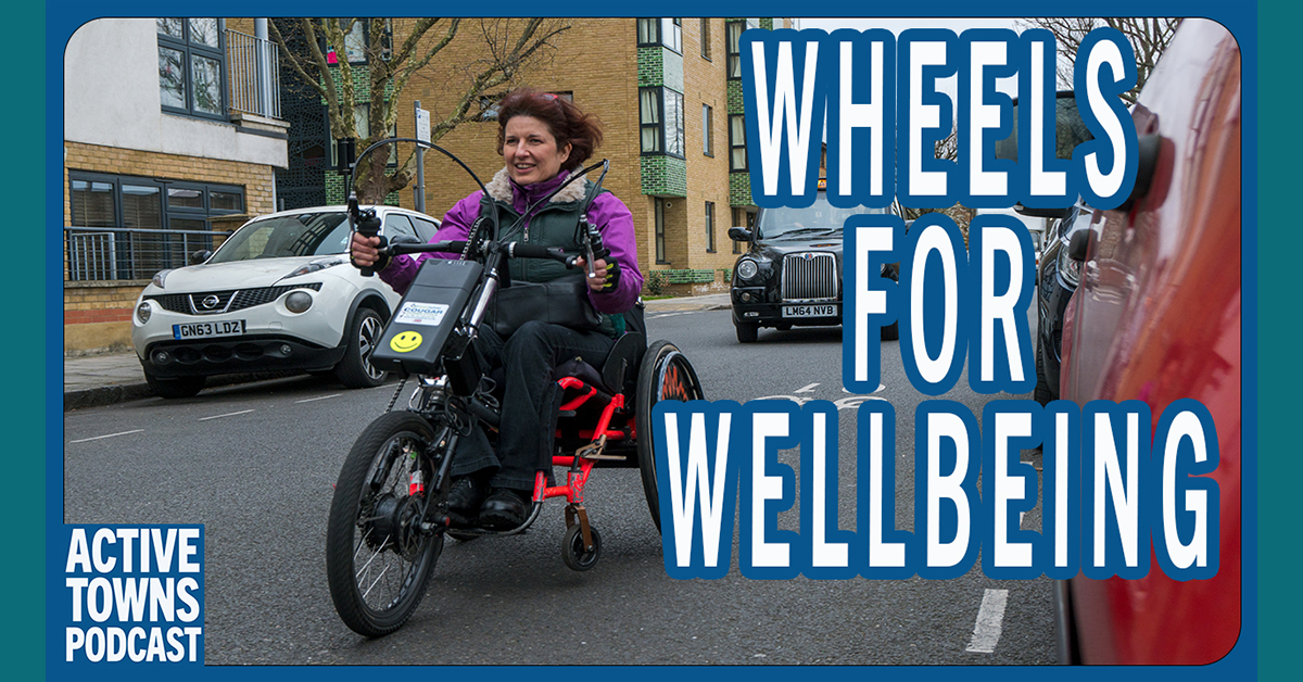 Isabelle is riding on an adaptive cycle on a quiet street in London