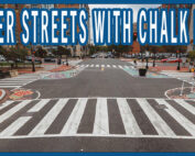 An intersection with asphalt art and flex post bulb-outs to slow cars down