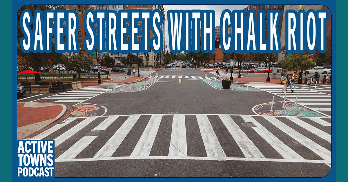 An intersection with asphalt art and flex post bulb-outs to slow cars down