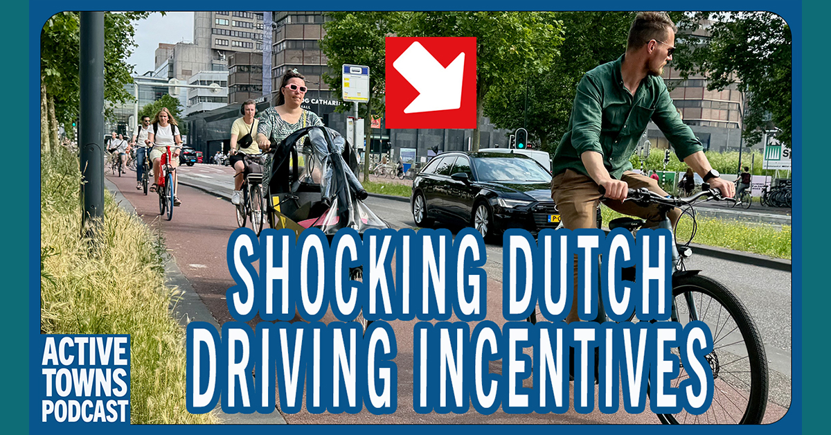 Busy bike lane in Utrecht with an arrow pointing to the car in the lane next to it