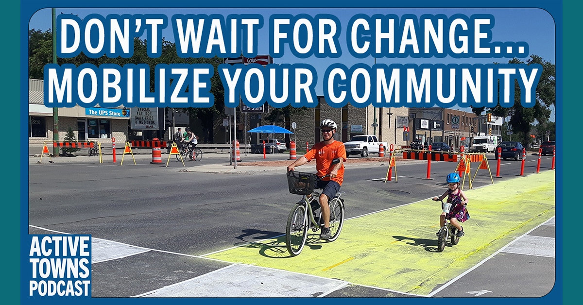 A dad and daughter riding bikes in a pop-up protected bike lane