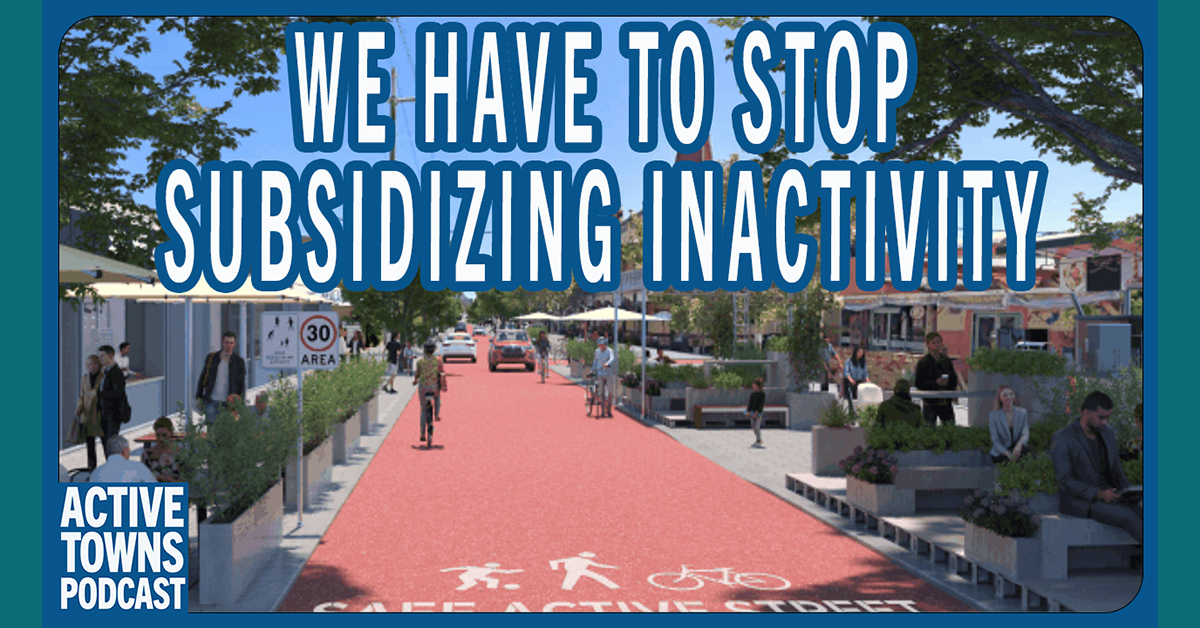 A reimagined people-oriented shared streetscape with red asphalt and cafe seating on the edges