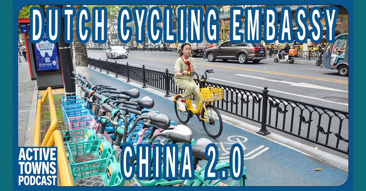 A women riding in a protected bike lane in China past a line of colorful shared bikes